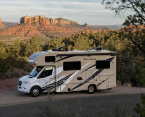 RV parked outside near trees and a canyon