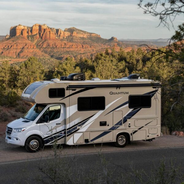 RV parked outside near trees and a canyon